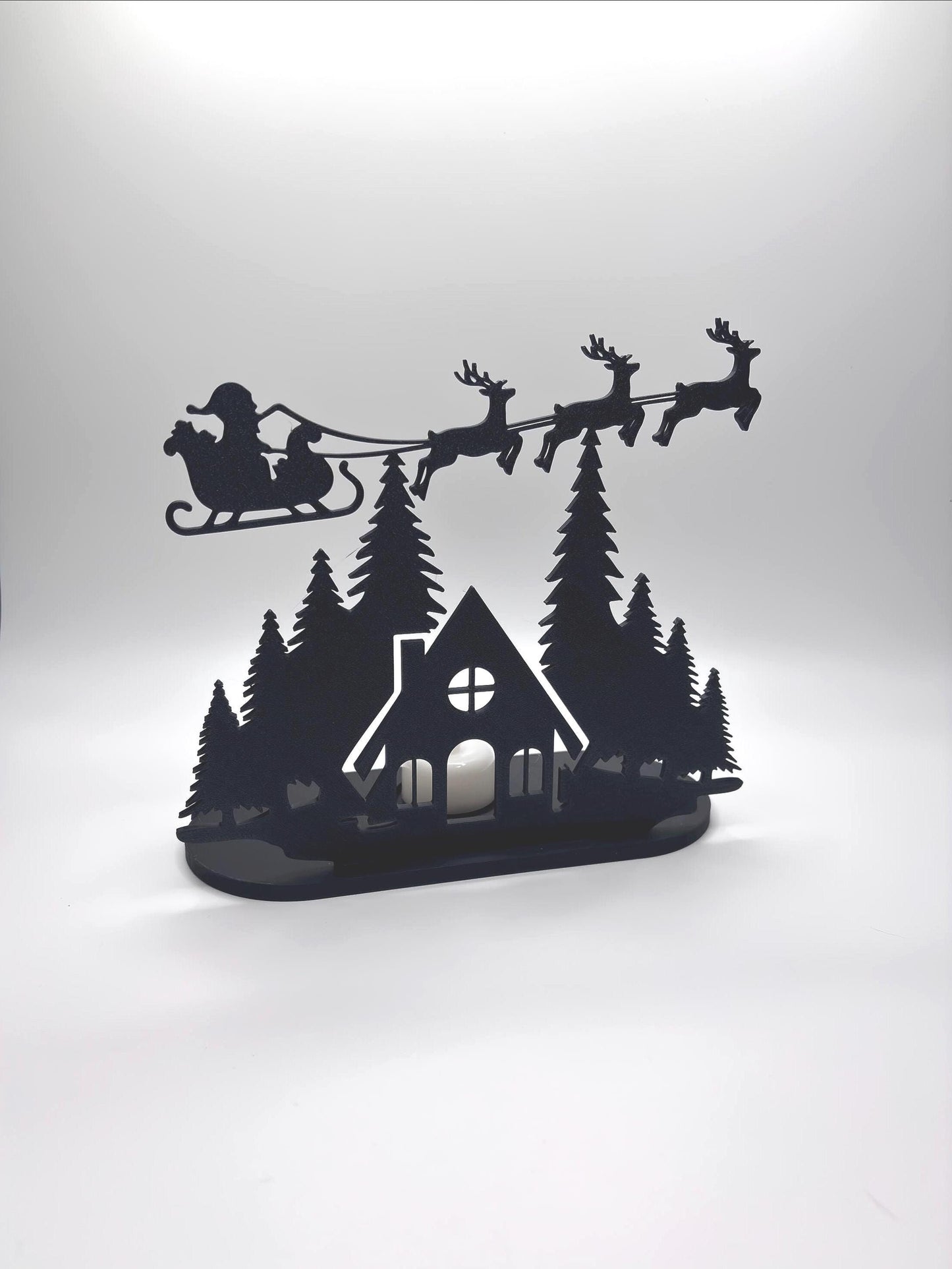 Christmas Tealight Display | Santa and his Reindeer Flying Over Cozy Woodland House