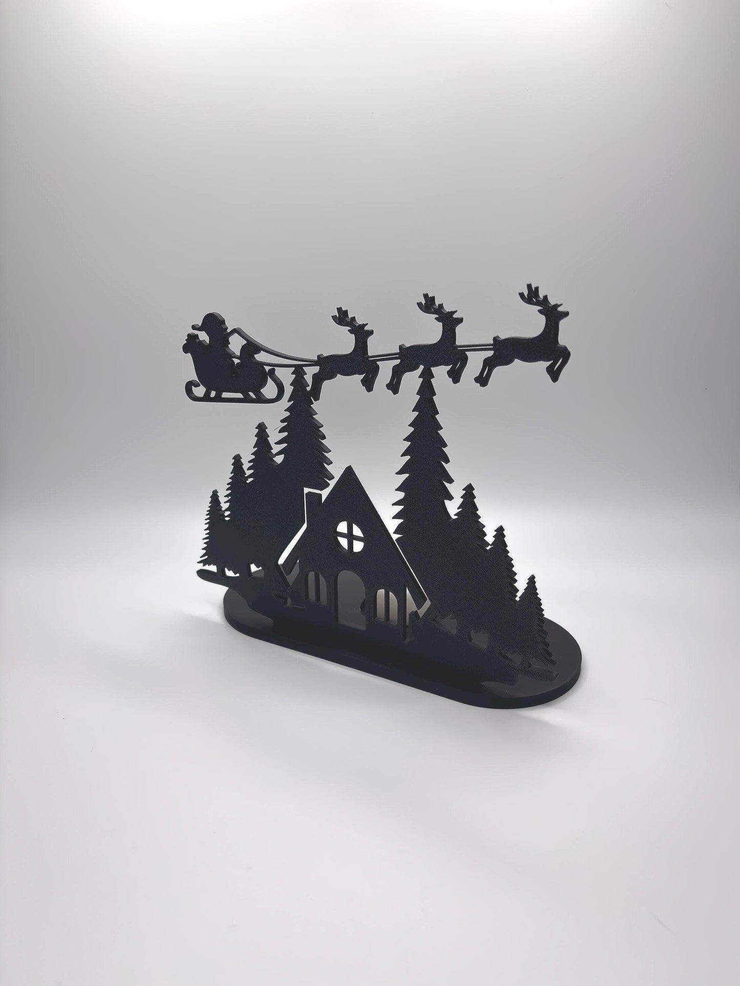 Christmas Tealight Display | Santa and his Reindeer Flying Over Cozy Woodland House