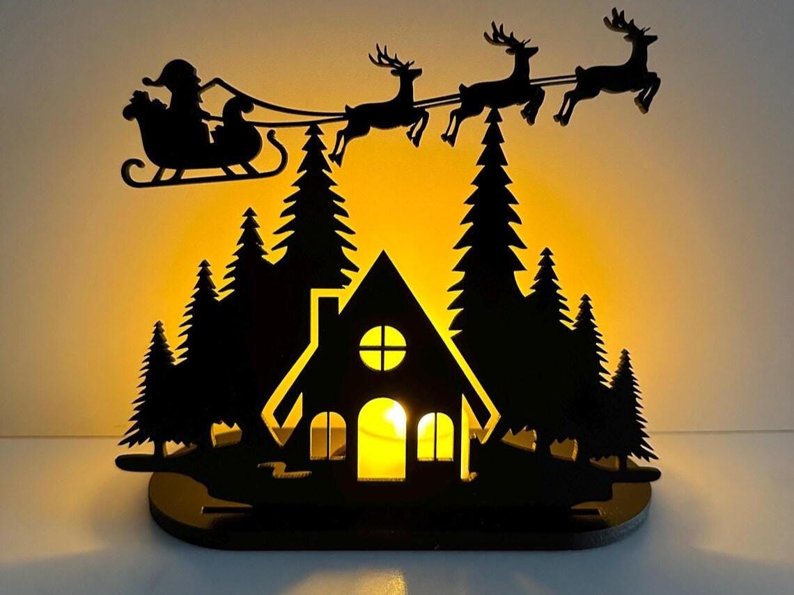 Christmas Tealight Display | Santa and his Reindeer Flying Over Cozy Woodland House